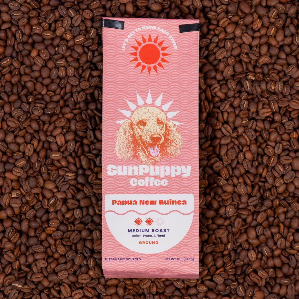Sunpuppy Coffee 12oz bag of Papua New Guinea medium roast ground coffee with pink wave pattern and dog logo on lime green background