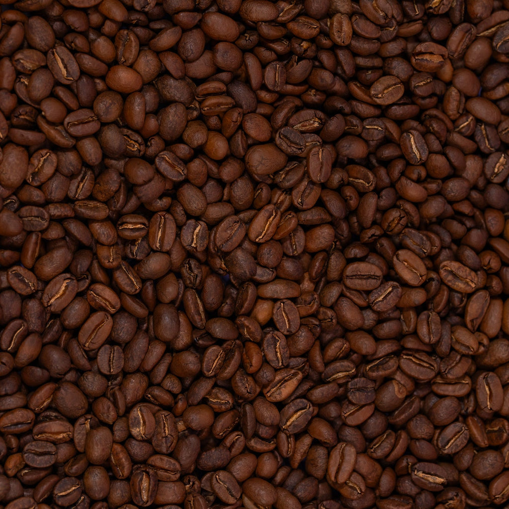 Close-up of coffee beans with a dark brown color.