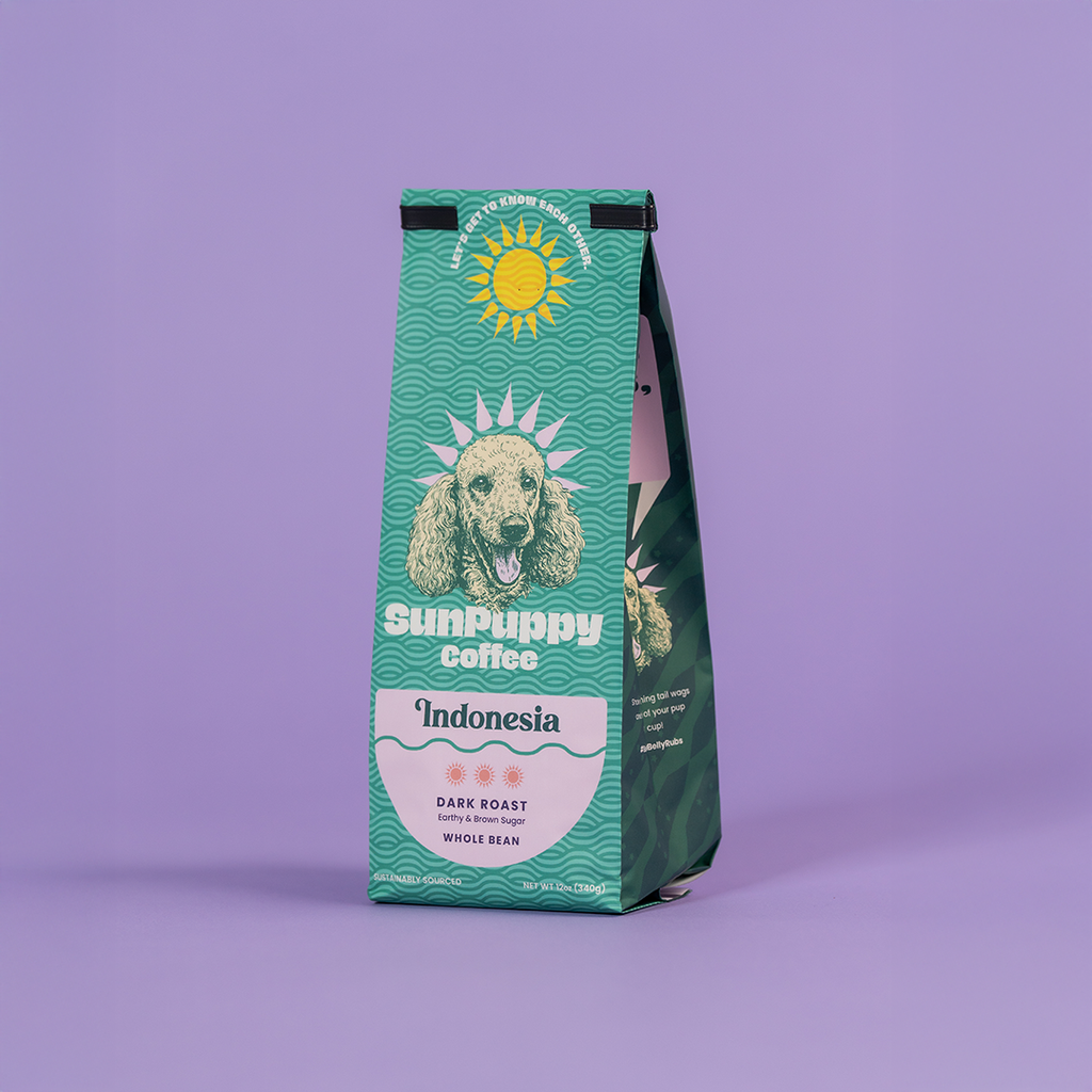 Sunpuppy Coffee Indonesian dark roast whole bean coffee in teal turquoise packaging featuring standard poodle mascot with sun logo on purple background 12 ounces