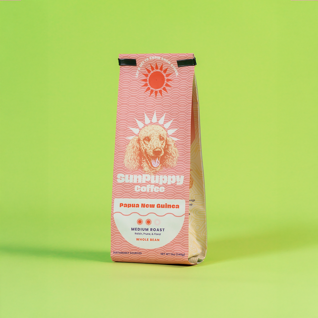 Sunpuppy Coffee 12oz bag of Papua New Guinea medium roast whole bean coffee with pink wave pattern and dog logo on lime green background