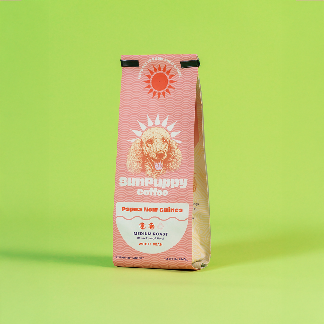 Sunpuppy Coffee 12oz bag of Papua New Guinea medium roast whole bean coffee with pink wave pattern and dog logo on lime green background