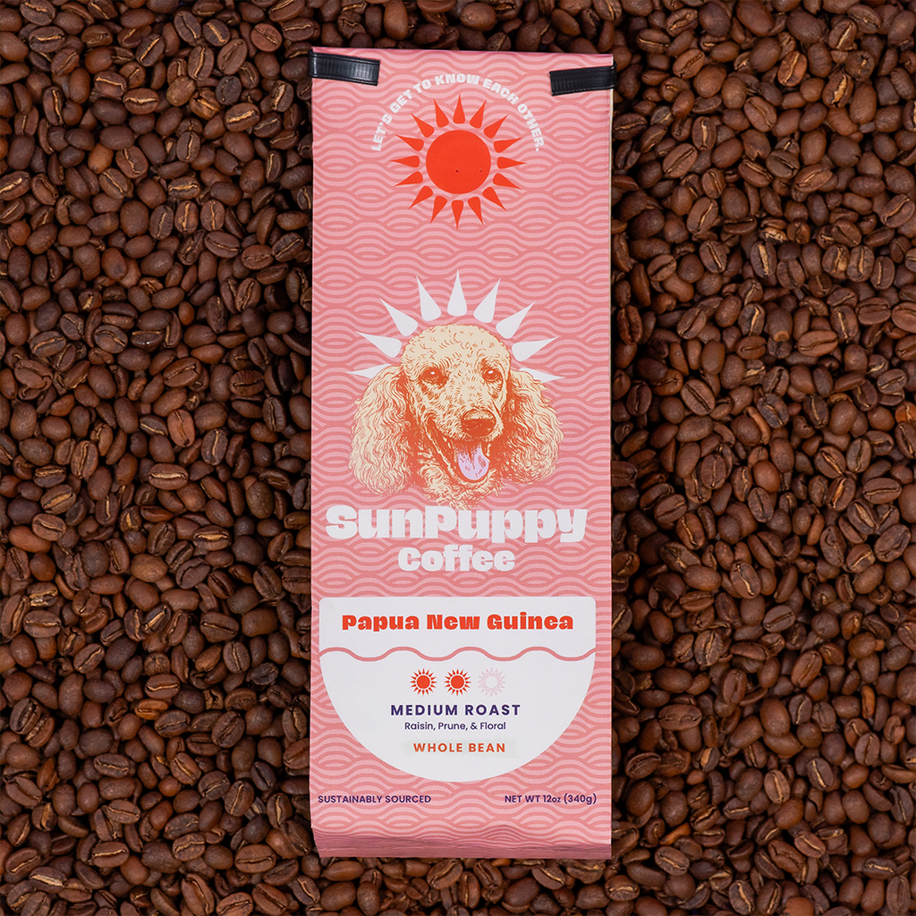 Sunpuppy Coffee 12oz bag of Papua New Guinea medium roast whole bean coffee with pink wave pattern and dog logo on lime green background